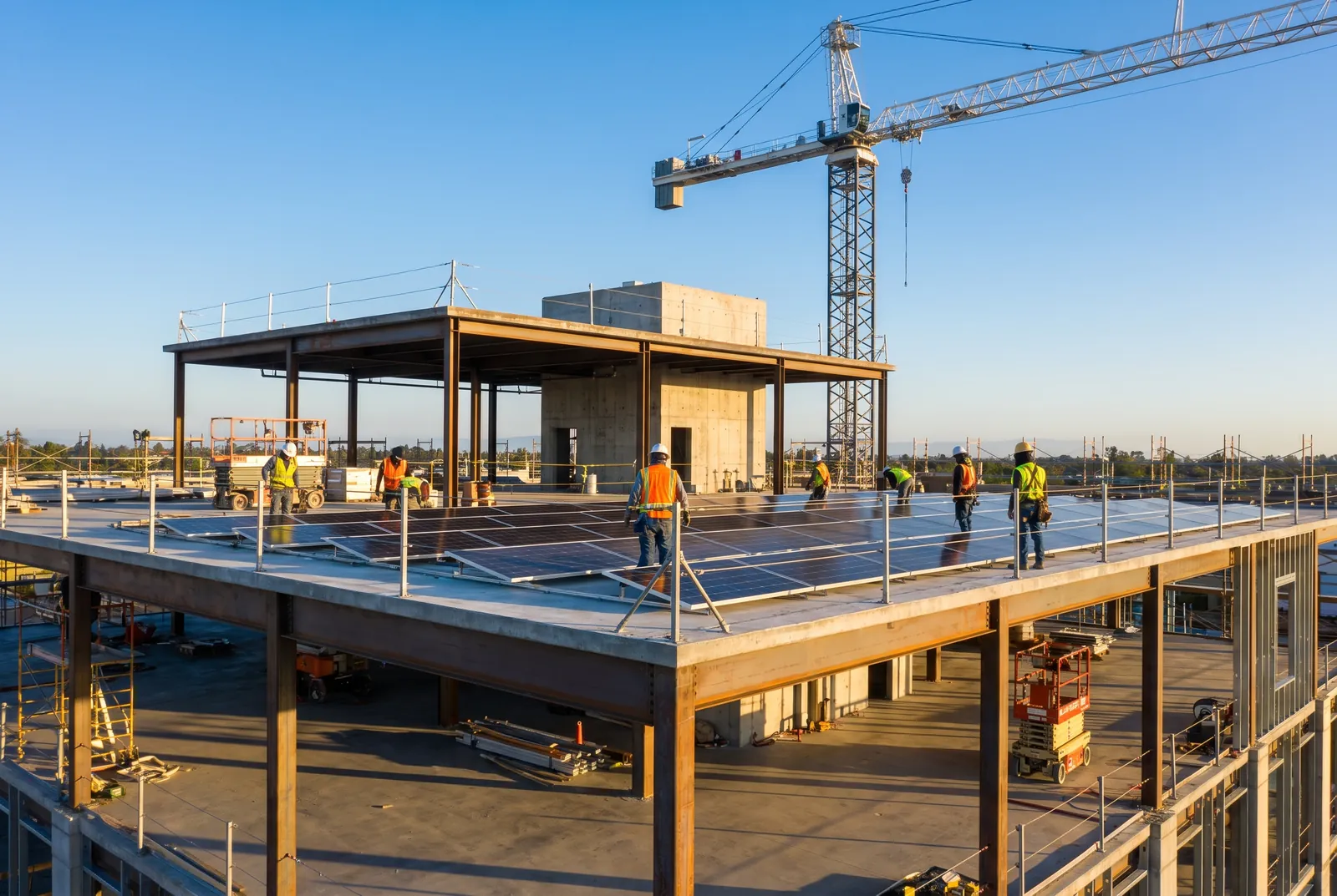 New commercial building under construction with rooftop solar installation in progress